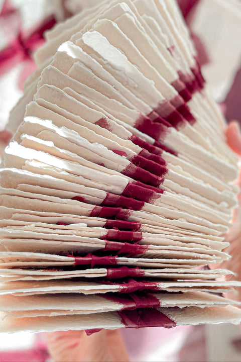 Romantic, rich, and full of timeless charm - this handmade paper wedding invitation suite is the perfect harmony of texture, elegance, and deep color. Each invitation is printed on luxurious cotton handmade paper with naturally deckled edges, exuding an organic and artisanal feel that makes every piece truly one of a kind. The suite is beautifully complemented by deep burgundy envelopes and tied with flowing silk chiffon ribbons in wine red, adding warmth, passion, and sophistication.