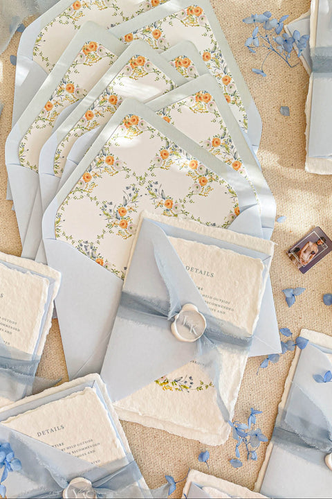 This exquisite wedding invitation set offers a blend of timeless charm and personal artistry. Perfect for a summer wedding, each suite features a custom, hand-painted watercolor monogram with a delicate floral design. Printed on luxurious handmade paper, these floral invites offer a rich, tactile experience and a unique, romantic preview of your special day.