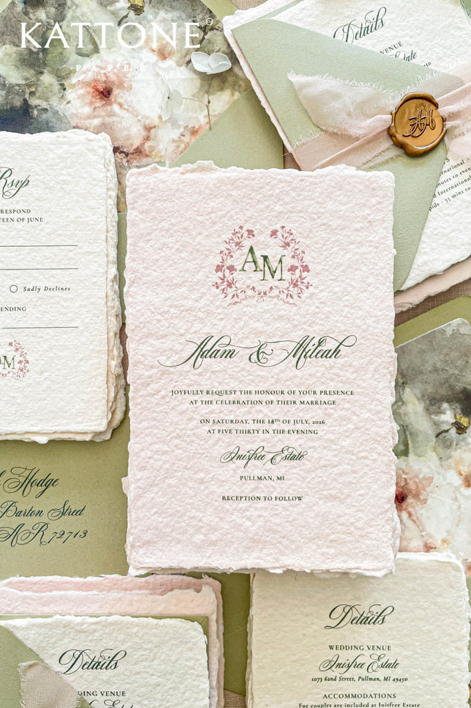 Elegant blush handmade paper wedding invitation with deckled edges featuring refined calligraphy typography and soft romantic styling.