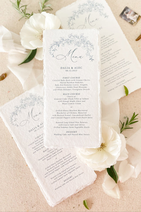 Add a touch of fine-art elegance to your event with our handmade paper wedding menus, featuring delicate blue floral illustrations and soft deckled edges. Each menu is printed on luxury cotton handmade paper, offering a naturally textured surface and an artisan feel that elevates any tablescape. Perfect for romantic weddings, garden celebrations, or intimate dinner parties, these menus combine artistry and craftsmanship - creating a refined keepsake your guests will adore.
