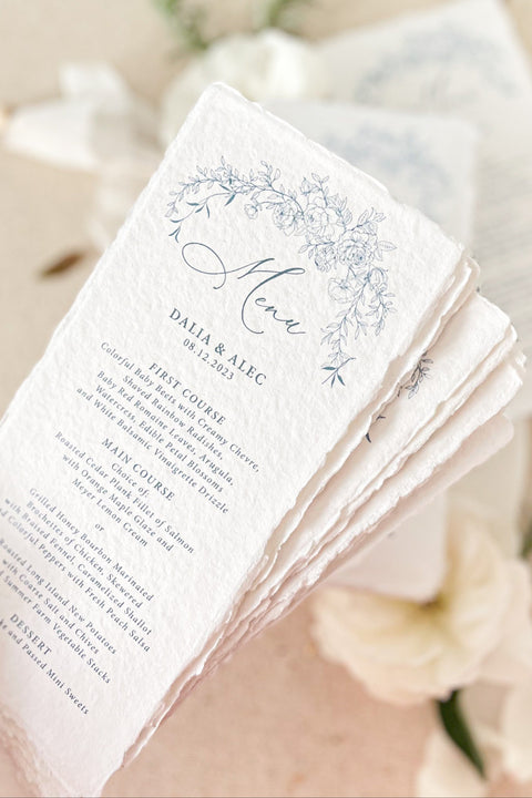 Add a touch of fine-art elegance to your event with our handmade paper wedding menus, featuring delicate blue floral illustrations and soft deckled edges. Each menu is printed on luxury cotton handmade paper, offering a naturally textured surface and an artisan feel that elevates any tablescape. Perfect for romantic weddings, garden celebrations, or intimate dinner parties, these menus combine artistry and craftsmanship - creating a refined keepsake your guests will adore.