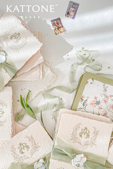 This handmade paper wedding invitation suite captures the essence of natural romance and bespoke craftsmanship. Printed on luxury cotton paper with beautifully deckled edges, each invitation is a tactile work of art that feels timeless and refined. The suite features a custom hand-drawn map, turning your wedding location into a cherished keepsake that guides guests with personal artistry.