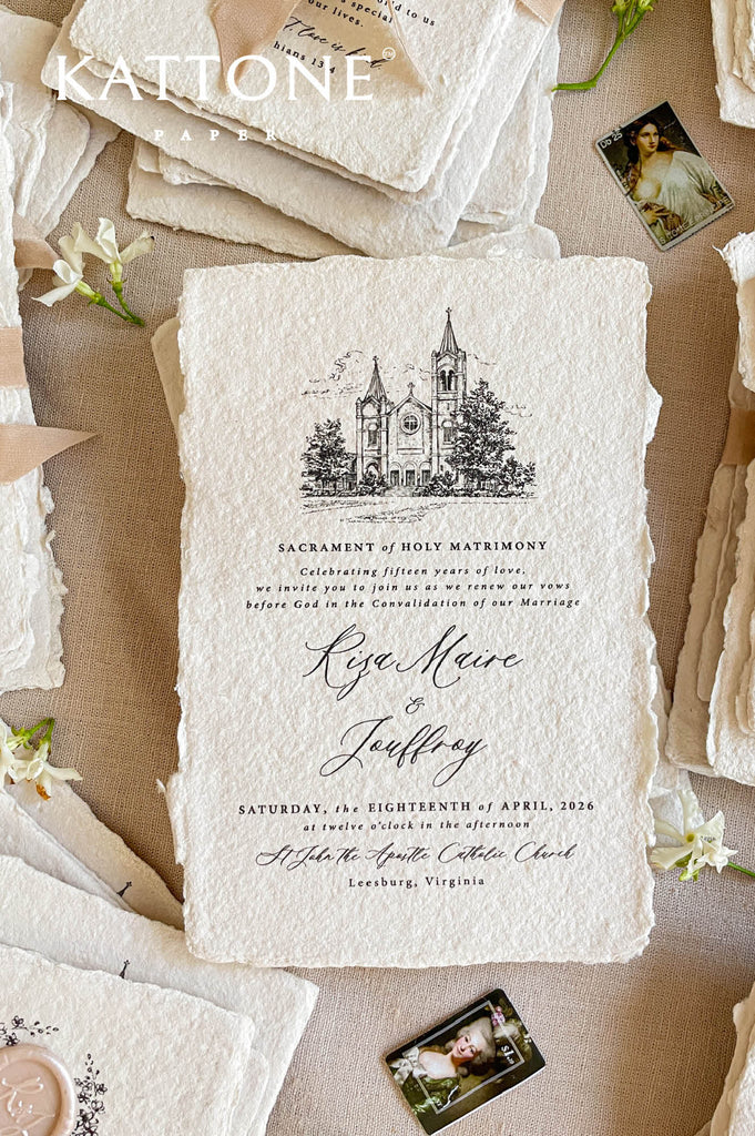 Close-up of handmade cotton paper wedding invitation featuring an illustrated church venue and elegant calligraphy.