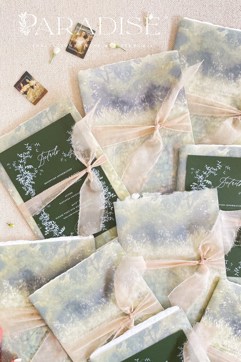 Announce your special day with timeless elegance through these handmade watercolor wreath wedding invitations — a perfect blend of artistry, romance, and personal touch. Each invitation features a delicately painted floral wreath, evoking natural beauty and heartfelt simplicity. Designed and assembled by hand, they set the tone for a wedding that’s both intimate and unforgettable.