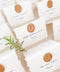 Elevate your wedding or event with our handmade paper place cards, crafted from luxurious cotton rag paper and finished with naturally torn deckled edges. Each card is adorned with a warm copper wax seal and elegant calligraphy, creating a timeless, fine-art detail that enhances any tablescape. Designed to bring organic texture, charm, and sophistication, these artisan place cards make your seating display unforgettable.