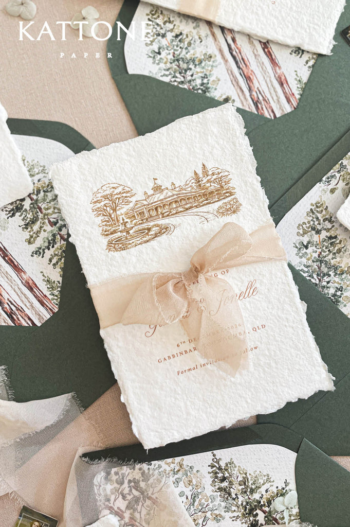 Soft beige chiffon ribbon tied around handmade save the date card creating a romantic presentation.