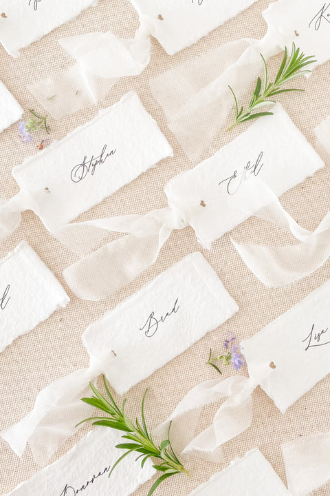 Bring timeless elegance to your table styling with our handmade paper place cards, crafted on luxury cotton paper with natural deckled edges. Perfect for fine-art, romantic, or destination weddings, each card combines minimalist typography with artisanal texture - the ideal finishing touch for a cohesive, refined tablescape. Personalize with each guest’s name for a bespoke and luxurious experience.