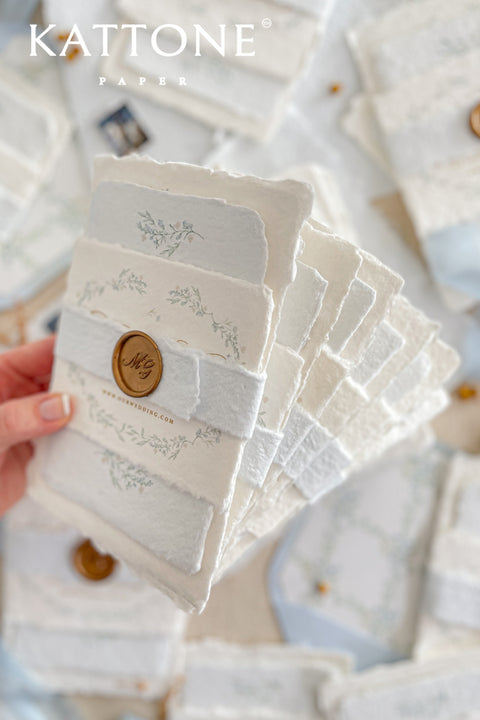 Embrace bohemian charm and natural elegance with the Alcina boho rustic stationery sets. Each handmade wedding invitation is a beautiful work of art, featuring luxurious cotton rag paper with a romantic deckle edge. To complete the bohemian feel, every suite is embellished with a delicate tassel, creating a uniquely personal and tactile experience for your guests. The combination of rustic textures and charming details makes this collection perfect for a relaxed and romantic celebration.