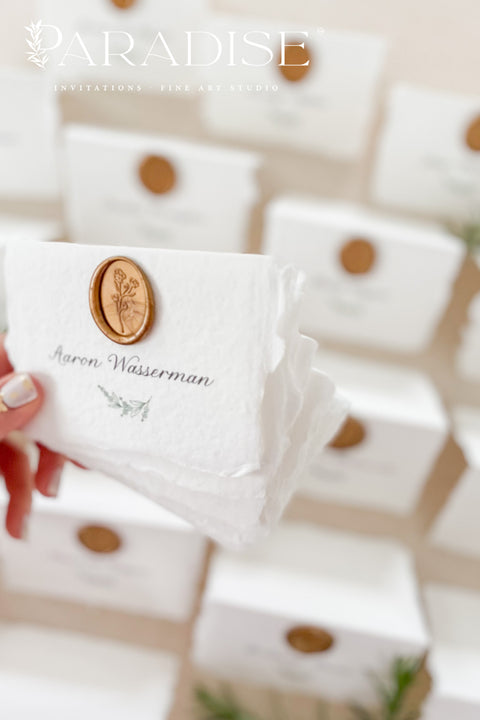 Elevate your wedding or event with our handmade paper place cards, crafted from luxurious cotton rag paper and finished with naturally torn deckled edges. Each card is adorned with a warm copper wax seal and elegant calligraphy, creating a timeless, fine-art detail that enhances any tablescape. Designed to bring organic texture, charm, and sophistication, these artisan place cards make your seating display unforgettable.