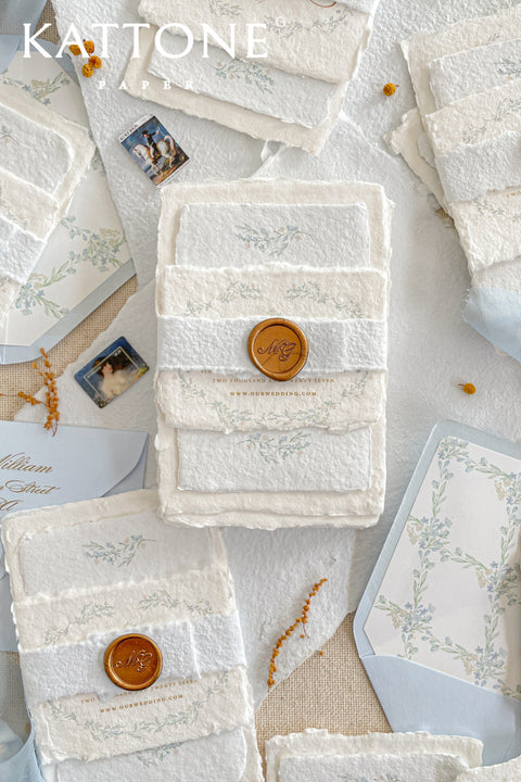 Embrace bohemian charm and natural elegance with the Alcina boho rustic stationery sets. Each handmade wedding invitation is a beautiful work of art, featuring luxurious cotton rag paper with a romantic deckle edge. To complete the bohemian feel, every suite is embellished with a delicate tassel, creating a uniquely personal and tactile experience for your guests. The combination of rustic textures and charming details makes this collection perfect for a relaxed and romantic celebration.