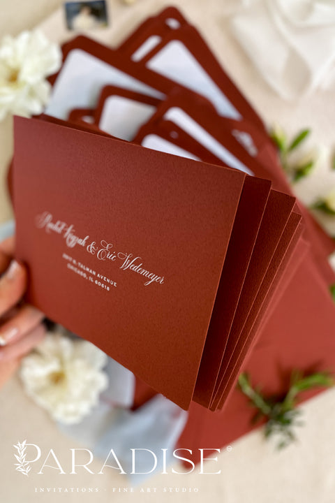 Red wedding envelopes with printed guest addresses and illustrated envelope liners, crafted from premium paper for luxury fine art invitation suites.