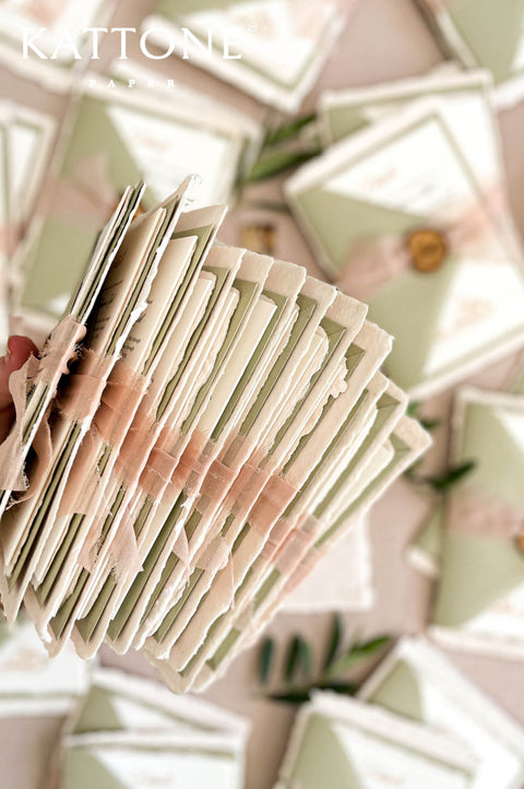 Complete luxury wedding invitation suite with handmade paper, sage envelopes, and romantic styling