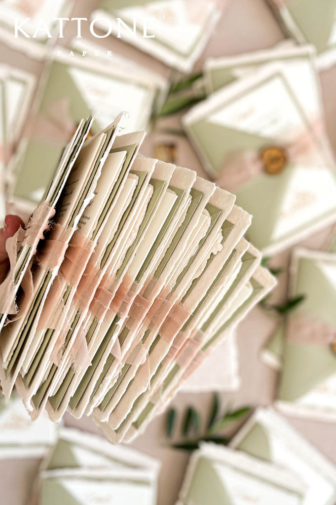 Complete luxury wedding invitation suite with handmade paper, sage envelopes, and romantic styling