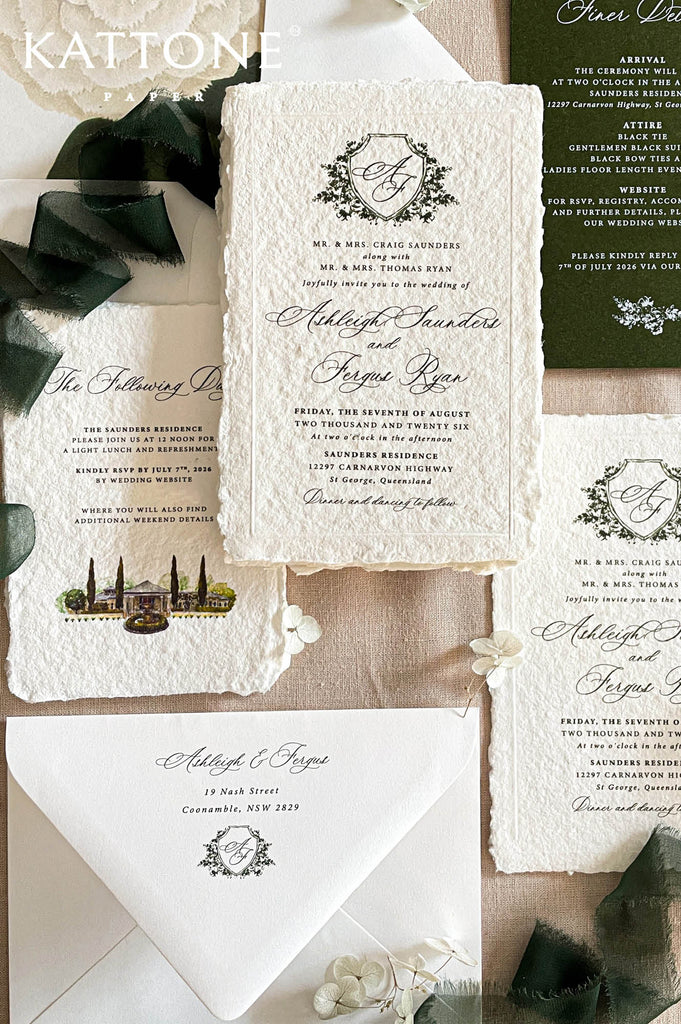 Luxury handmade paper wedding invitation suite featuring deckled-edge cotton paper, deep green backing cards, vellum wraps, chiffon ribbon, wax seals, and botanical crest artwork.