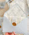 Light blue wedding envelopes with watercolor floral envelope liners held in hand, featuring soft pastel tones, wax seal detail, and fine art stationery styling.