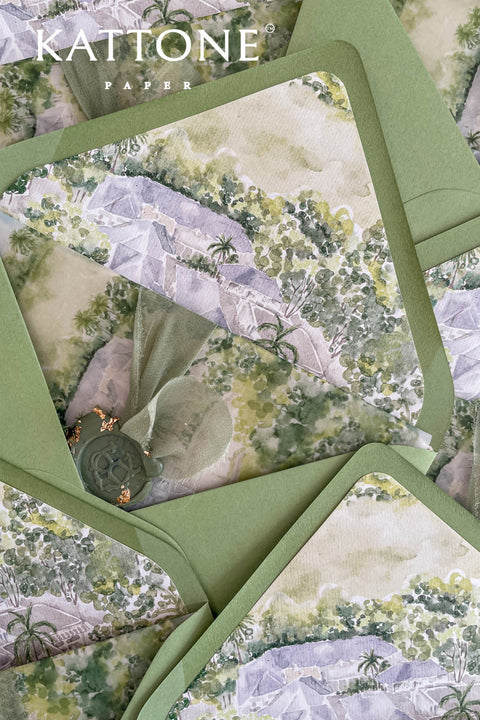 Close-up of watercolor venue illustration inside pear green envelope showing soft landscape painting and refined paper texture.