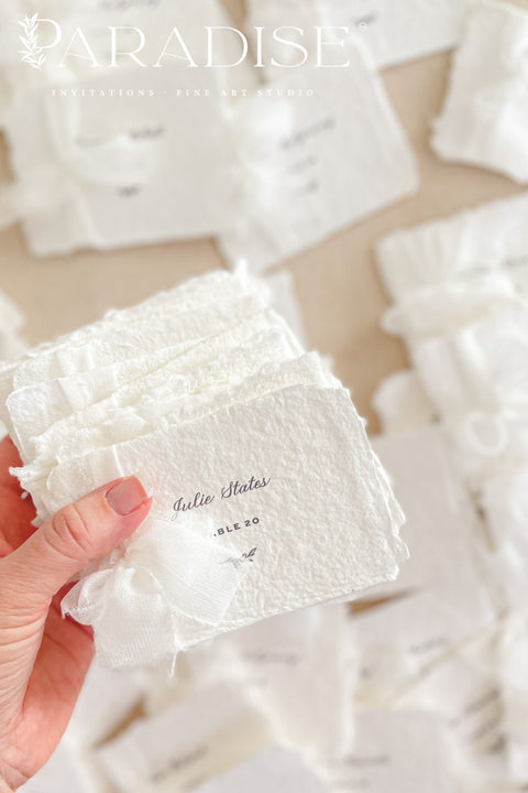 Elevate your event with our handmade paper place cards, crafted from luxurious cotton rag paper and finished with soft, natural deckled edges. Each card is delicately wrapped with fine chiffon ribbon and printed in elegant calligraphy, creating a timeless, romantic detail for weddings, bridal showers, and upscale celebrations. These artisan-crafted pieces add a soft, ethereal charm to any tablescape and photograph beautifully for your flatlays.