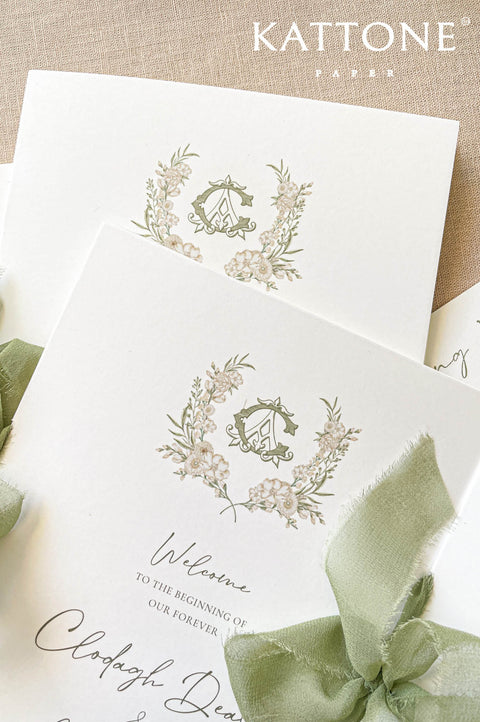 Textured wedding program with botanical monogram and refined calligraphy.