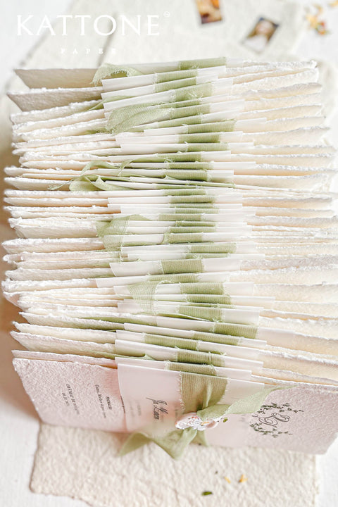 This handmade paper wedding invitation suite captures the essence of natural romance and bespoke craftsmanship. Printed on luxury cotton paper with beautifully deckled edges, each invitation is a tactile work of art that feels timeless and refined. The suite features a custom hand-drawn map, turning your wedding location into a cherished keepsake that guides guests with personal artistry.