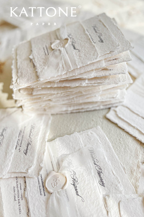 Timeless, refined, and elegantly understated - these handmade paper wedding invitations embody the essence of fine art craftsmanship. Printed on luxury cotton handmade paper with naturally deckled edges, each invitation feels soft, organic, and beautifully textured, creating a sense of warmth and authenticity from the very first touch. Each suite is wrapped in a silk ribbon and finished with wax seal monogram, adding a bespoke touch that symbolizes intimacy and attention to detail.