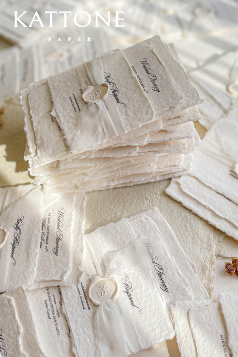Timeless, refined, and elegantly understated - these handmade paper wedding invitations embody the essence of fine art craftsmanship. Printed on luxury cotton handmade paper with naturally deckled edges, each invitation feels soft, organic, and beautifully textured, creating a sense of warmth and authenticity from the very first touch. Each suite is wrapped in a silk ribbon and finished with wax seal monogram, adding a bespoke touch that symbolizes intimacy and attention to detail.