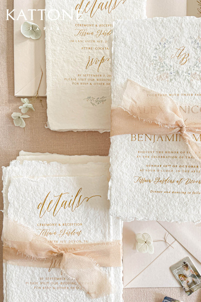 Soft blush chiffon ribbon wrapped around handmade paper wedding invitations adds movement, softness, and romantic layered styling.