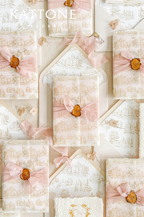 This exquisite wedding invitations suite offers a blend of timeless charm and personalized artistry. The suite features beautiful pretty stationery enclosed in a translucent custom toile de jouy vellum jacket, printed with your unique custom crest monogram. The result is a truly elegant and memorable keepsake that sets a romantic and intimate tone for your special day.