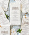 Handmade paper wedding menu with deckled edges and custom venue illustration, fine art reception stationery flat lay.