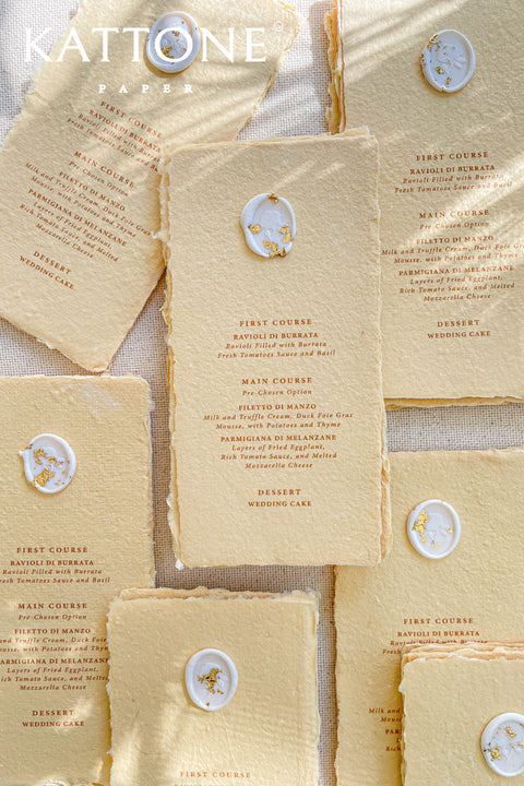 These colored handmade paper wedding menus radiate elegance and warmth, blending artisanal craftsmanship with refined design. Made from 100% cotton rag paper, each menu features a beautifully textured surface and softly deckled edges that embody the charm of traditional papermaking. The delicate buttercream hue adds a touch of sophistication, perfectly balancing modern minimalism with romantic authenticity.