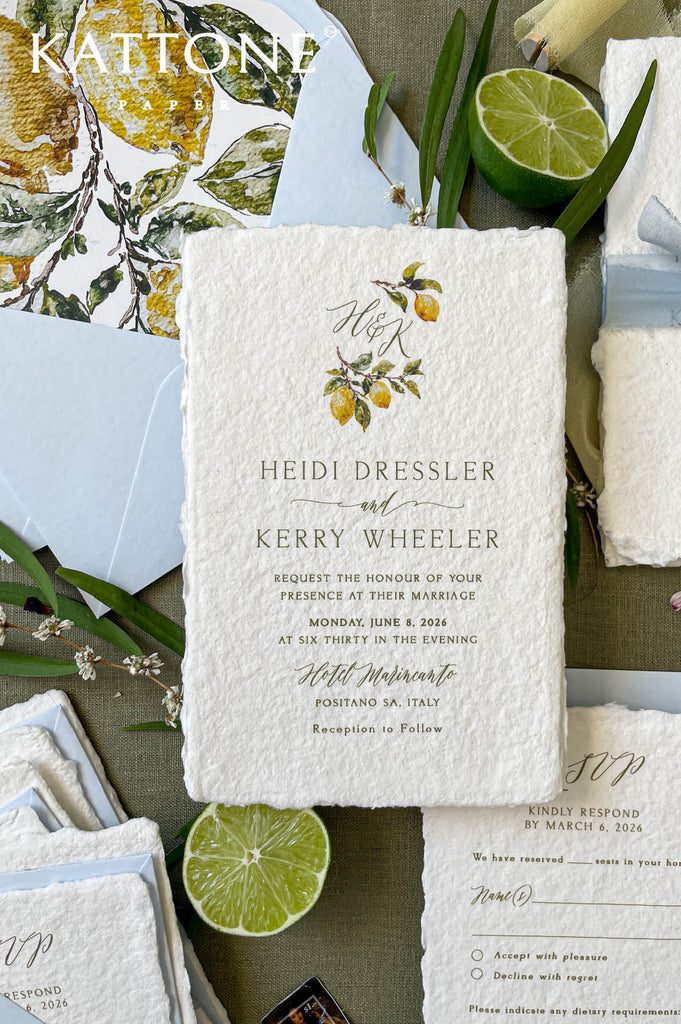 Soft blue wedding envelopes wrapped with silk ribbon and finished with a custom wax seal, paired with lemon wedding invitations.