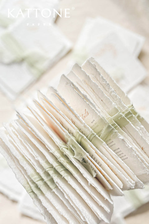 This handmade paper wedding invitation suite captures the essence of natural romance and bespoke craftsmanship. Printed on luxury cotton paper with beautifully deckled edges, each invitation is a tactile work of art that feels timeless and refined. The suite features a custom hand-drawn map, turning your wedding location into a cherished keepsake that guides guests with personal artistry.