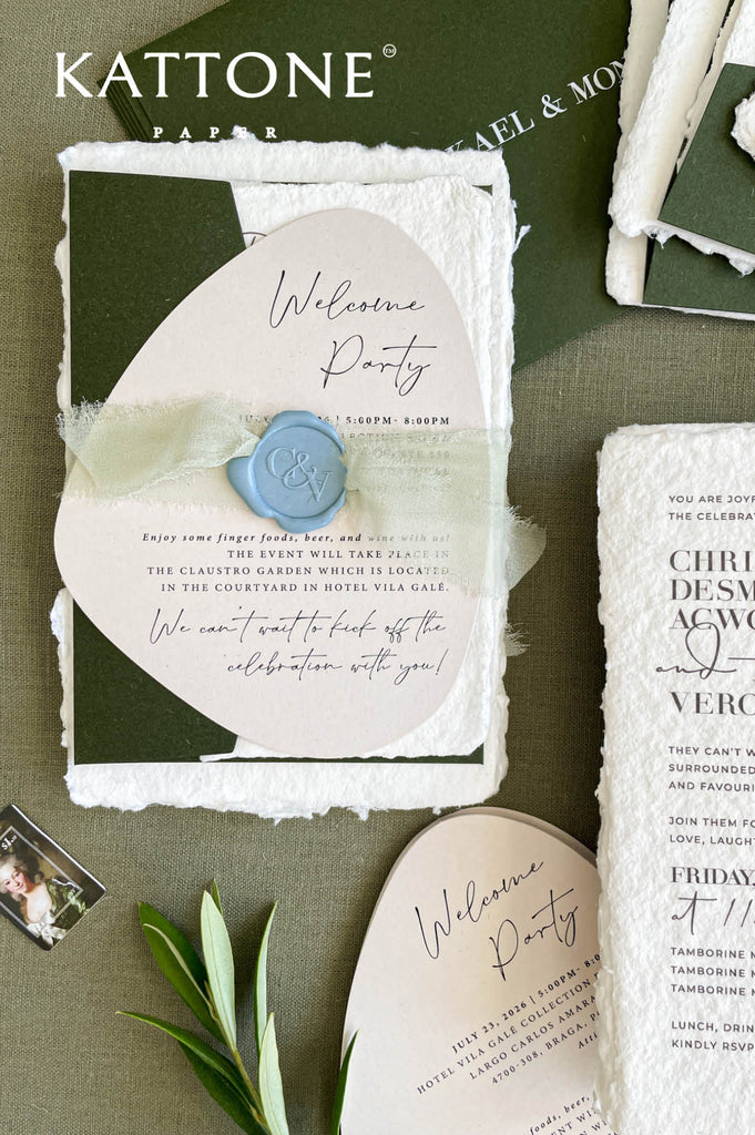 Close-up of handmade cotton paper wedding invitation featuring textured deckle edges and refined modern typography.