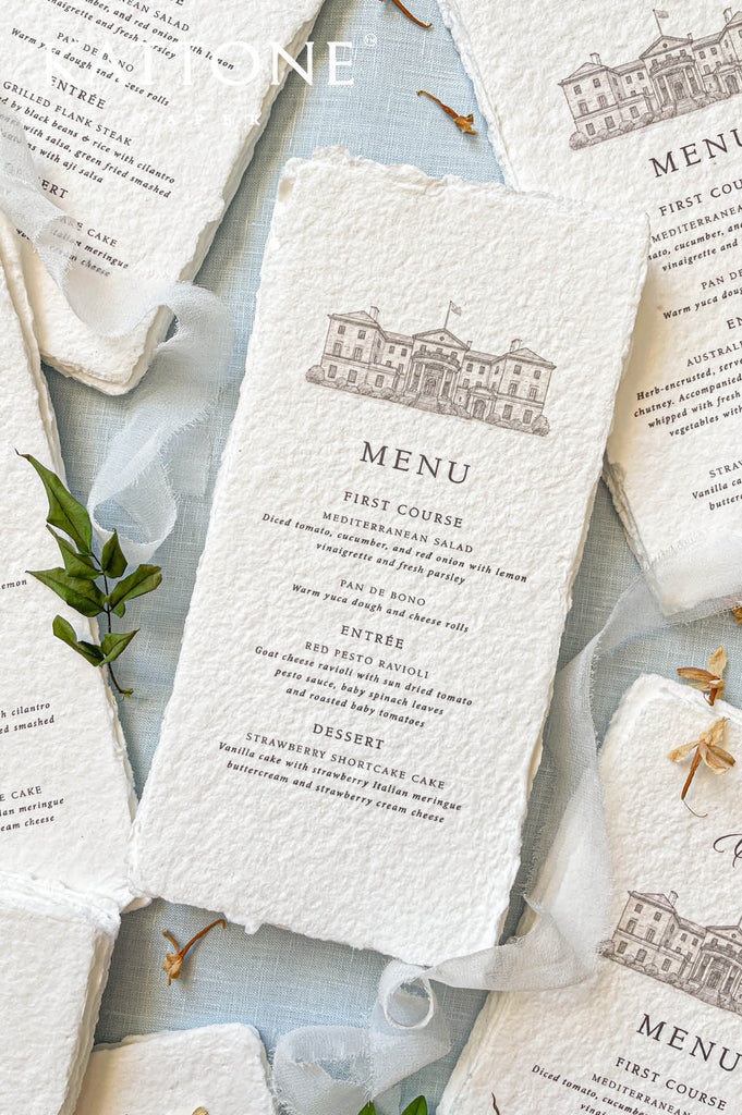 Luxury wedding menu printed on handmade cotton paper with organic deckled edges and soft textured surface.