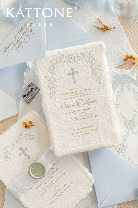 A serene and faith-inspired christening invitation crafted from luxurious handmade paper and adorned with soft watercolor botanicals. Featuring a delicate floral wreath and subtle Christian cross, this design blends timeless elegance with gentle color and refined typography. Perfect for baptisms and church ceremonies, it offers a meaningful keepsake that beautifully honors this sacred milestone.
