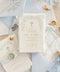 A serene and faith-inspired christening invitation crafted from luxurious handmade paper and adorned with soft watercolor botanicals. Featuring a delicate floral wreath and subtle Christian cross, this design blends timeless elegance with gentle color and refined typography. Perfect for baptisms and church ceremonies, it offers a meaningful keepsake that beautifully honors this sacred milestone.
