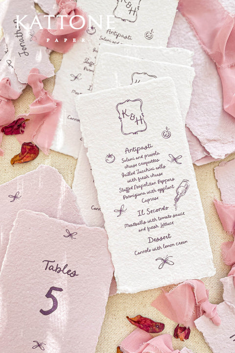 Delight your guests with our handmade paper menus with whimsical icons, featuring charming hand-drawn illustrations and organic deckled edges. Crafted from soft cotton paper, these menus bring a touch of artful playfulness and fine-art texture to your wedding tablescape. Perfect for couples who love romantic, storybook-style stationery that feels both elegant and personal.