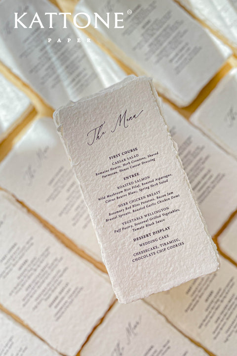 Elevate your tablescape with our handmade paper wedding menus, meticulously crafted from luxury cotton paper with naturally torn deckled edges. Each piece exudes timeless refinement - perfect for romantic, fine-art, or destination weddings. Featuring minimalist typography and soft organic texture, these menus create a cohesive, elegant setting that beautifully complements your stationery suite and enhances your guests’ dining experience.