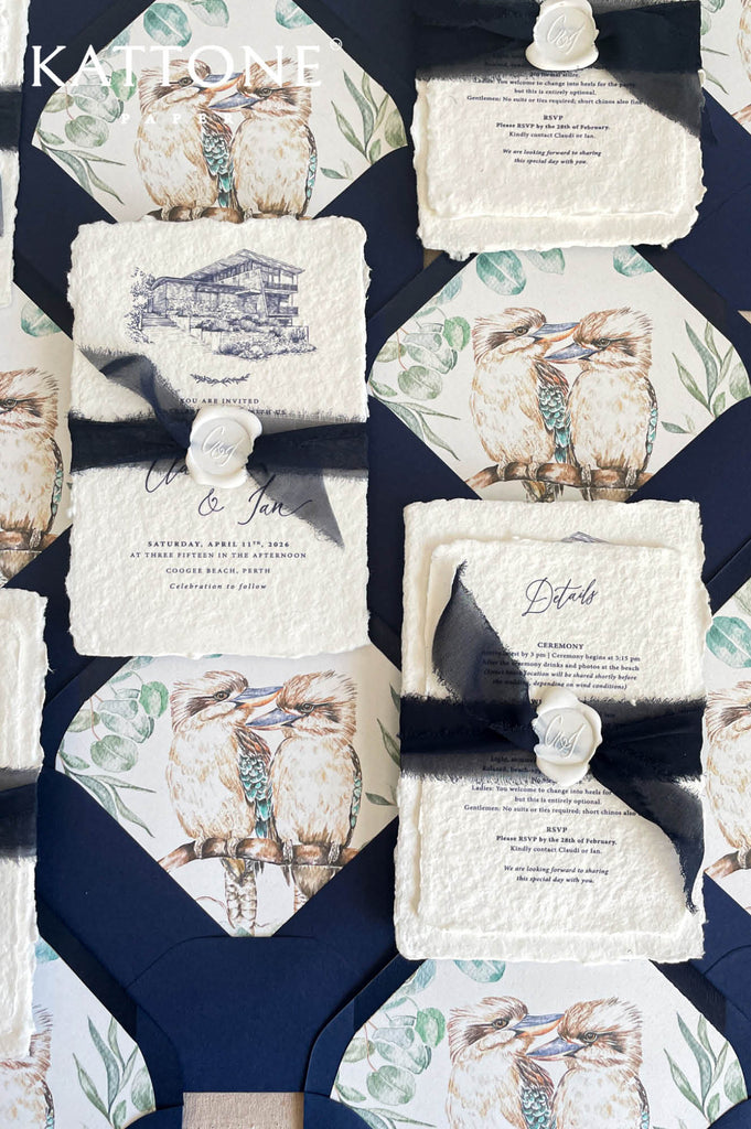 Complete luxury wedding invitation suite including handmade invitation, illustrated inserts, navy envelopes, ribbon and wax seal accents.