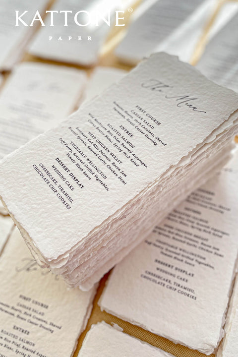 Elevate your tablescape with our handmade paper wedding menus, meticulously crafted from luxury cotton paper with naturally torn deckled edges. Each piece exudes timeless refinement - perfect for romantic, fine-art, or destination weddings. Featuring minimalist typography and soft organic texture, these menus create a cohesive, elegant setting that beautifully complements your stationery suite and enhances your guests’ dining experience.