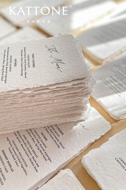 Elevate your tablescape with our handmade paper wedding menus, meticulously crafted from luxury cotton paper with naturally torn deckled edges. Each piece exudes timeless refinement - perfect for romantic, fine-art, or destination weddings. Featuring minimalist typography and soft organic texture, these menus create a cohesive, elegant setting that beautifully complements your stationery suite and enhances your guests’ dining experience.