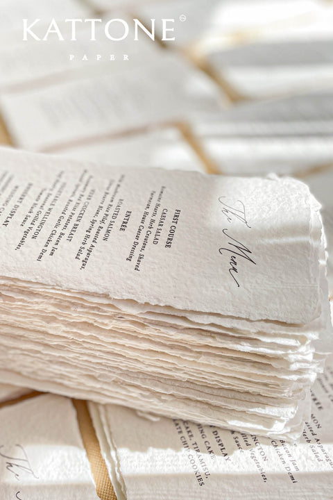 Elevate your tablescape with our handmade paper wedding menus, meticulously crafted from luxury cotton paper with naturally torn deckled edges. Each piece exudes timeless refinement - perfect for romantic, fine-art, or destination weddings. Featuring minimalist typography and soft organic texture, these menus create a cohesive, elegant setting that beautifully complements your stationery suite and enhances your guests’ dining experience.