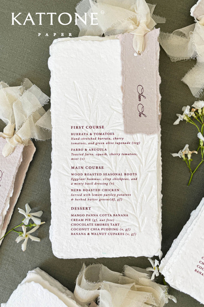 Wedding reception table styling with handmade paper menus and fine-art stationery details.