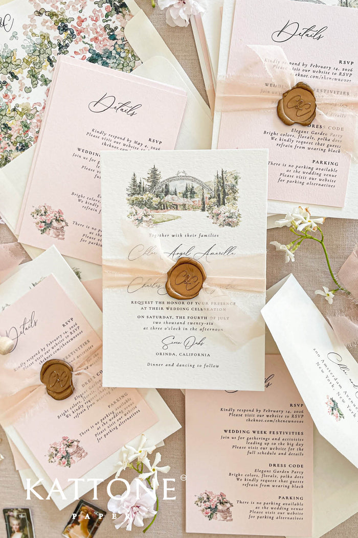 Wedding invitations with a custom watercolor venue illustration, printed on textured handmade paper with silk ribbon and wax seal details.