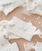 Handmade paper wedding place cards with deckled edges, personalized calligraphy names, romantic fine art table styling.