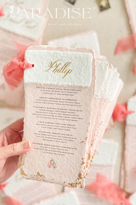 Bring a burst of color and elegance to your table setting with our colored handmade paper wedding menus, crafted from luxurious 100% cotton rag paper. These exquisite menus feature soft blush-pink tones, deckled edges, and gold foil calligraphy, creating a romantic and elevated aesthetic for any celebration. Each menu is finished with a vibrant coral silk ribbon and personalized name tag, combining artistry and function by doubling as both a menu and a place card. 