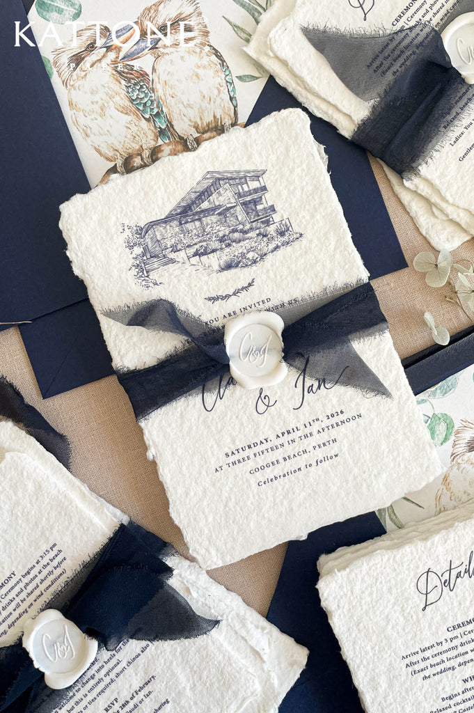 Close up of handmade cotton paper invitation highlighting textured deckled edges, architectural sketch and elegant typography.