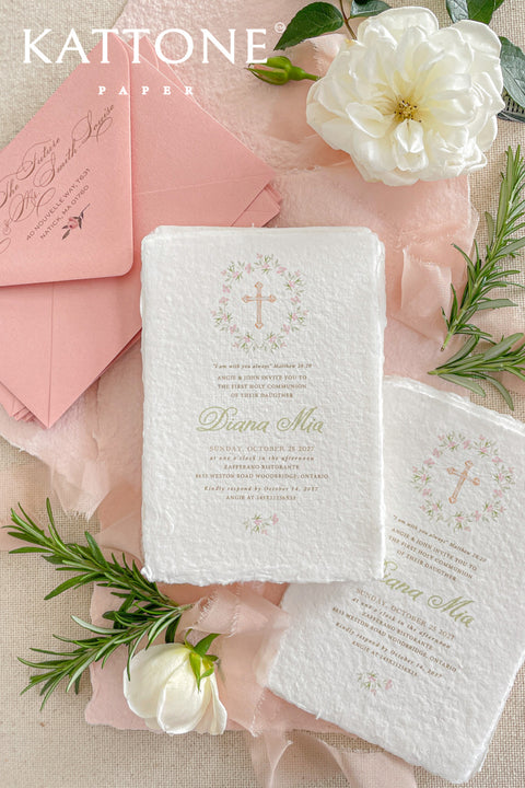 A soft and elegant christening invitation crafted from luxurious handmade paper and finished with a blush chiffon ribbon. Featuring a delicate watercolor floral wreath and subtle Christian cross, this design beautifully celebrates faith, innocence, and new beginnings. Perfect for baptisms, christenings, and church ceremonies, it creates a heartfelt keepsake your family will treasure.