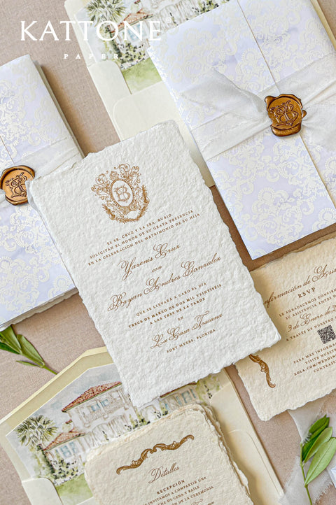 Fine art handmade paper wedding invitation suite with crest monogram, wax seal, watercolor liners, and classic European styling.