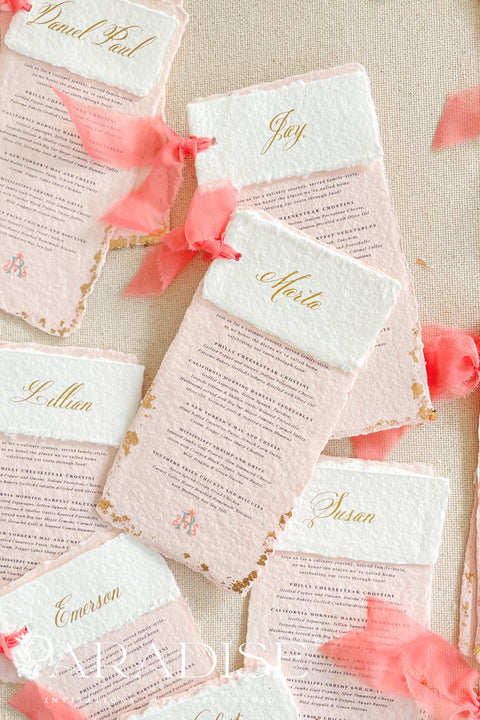 Bring a burst of color and elegance to your table setting with our colored handmade paper wedding menus, crafted from luxurious 100% cotton rag paper. These exquisite menus feature soft blush-pink tones, deckled edges, and gold foil calligraphy, creating a romantic and elevated aesthetic for any celebration. Each menu is finished with a vibrant coral silk ribbon and personalized name tag, combining artistry and function by doubling as both a menu and a place card. 