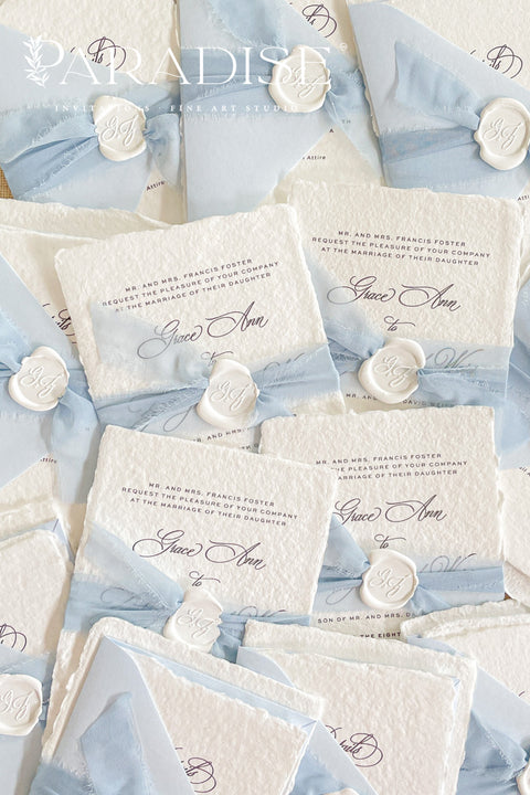 Announce your special day with a touch of coastal elegance and bohemian chic with this unique beach wedding invitations suite. Perfect for a seaside celebration, this elegant wedding stationery set combines classic details with a relaxed feel. Each invite is finished with a personalized wax seal, adding a luxurious, tactile element that makes a memorable first impression.